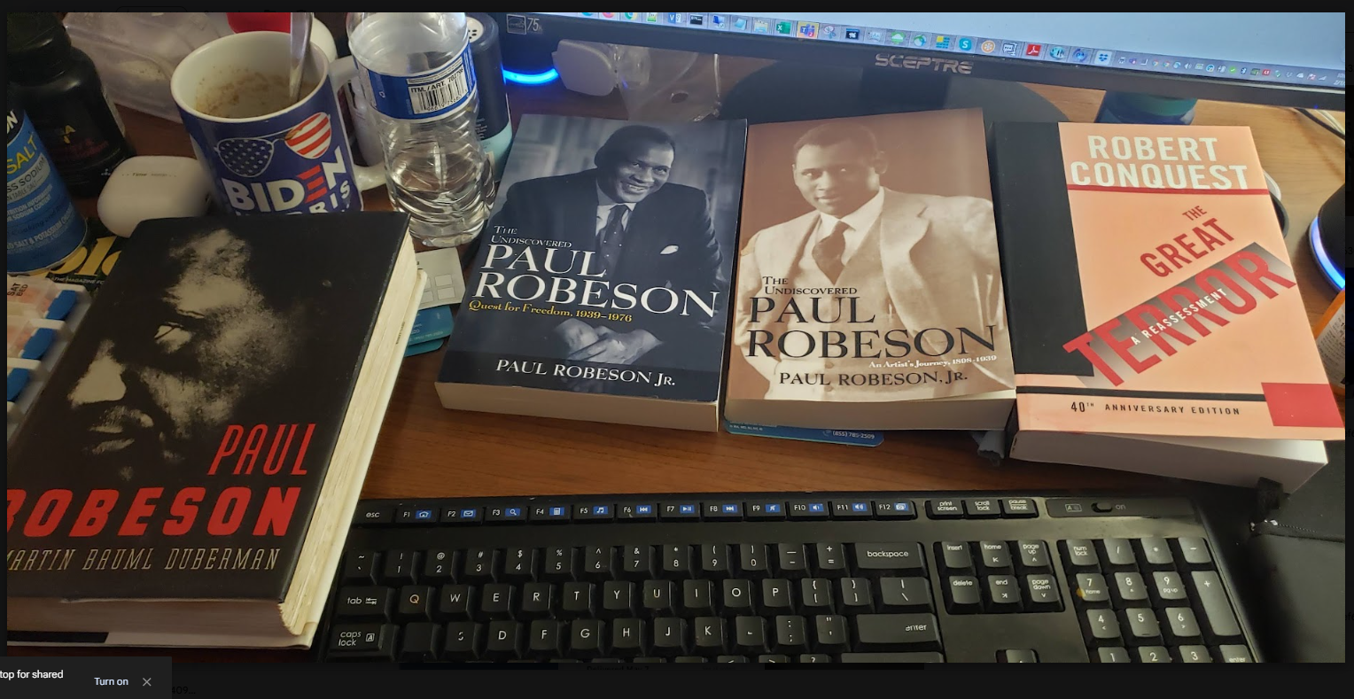 Books on a research desk: Paul Robeson biographies and Robert Conquest’s The Great Terror