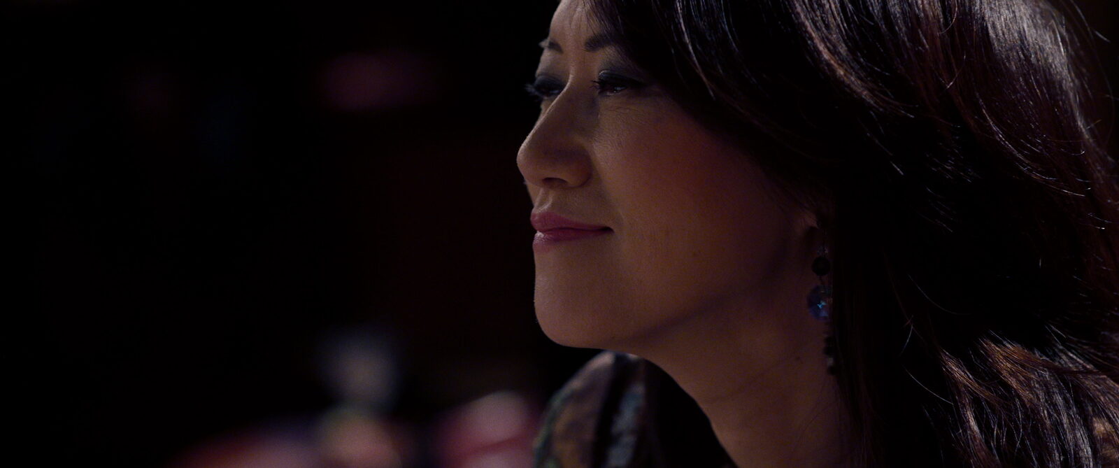 Yoko Miwa in a warmly lit close-up during filming for Fadeless Flower